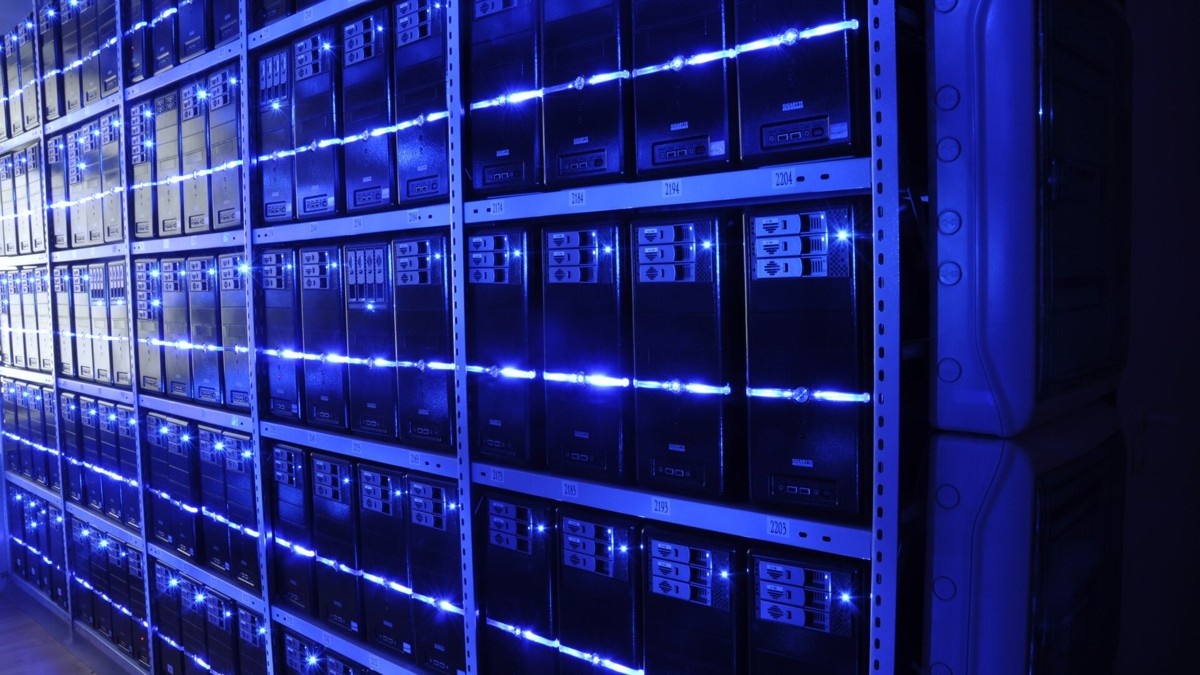 Rows of lit servers on shelves in a data center