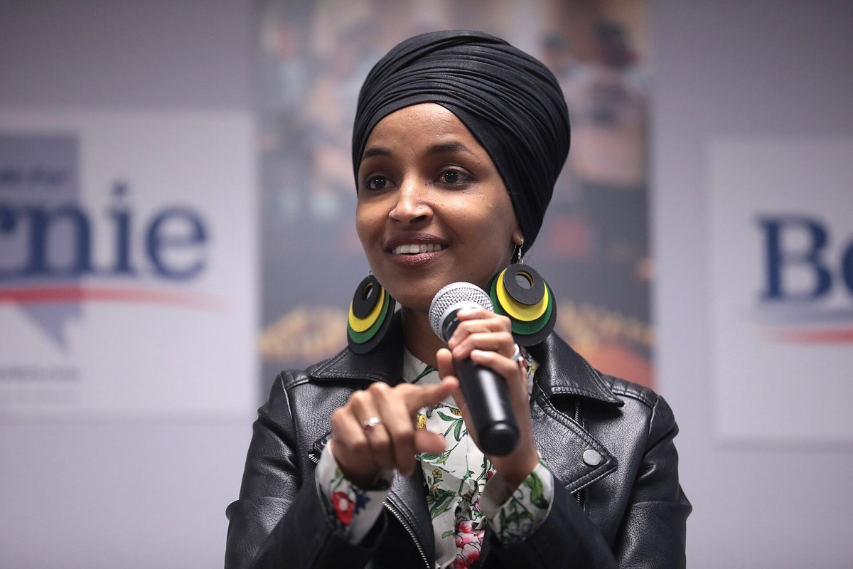 Rep. Ilhan Omar speaking into a microphone at an event