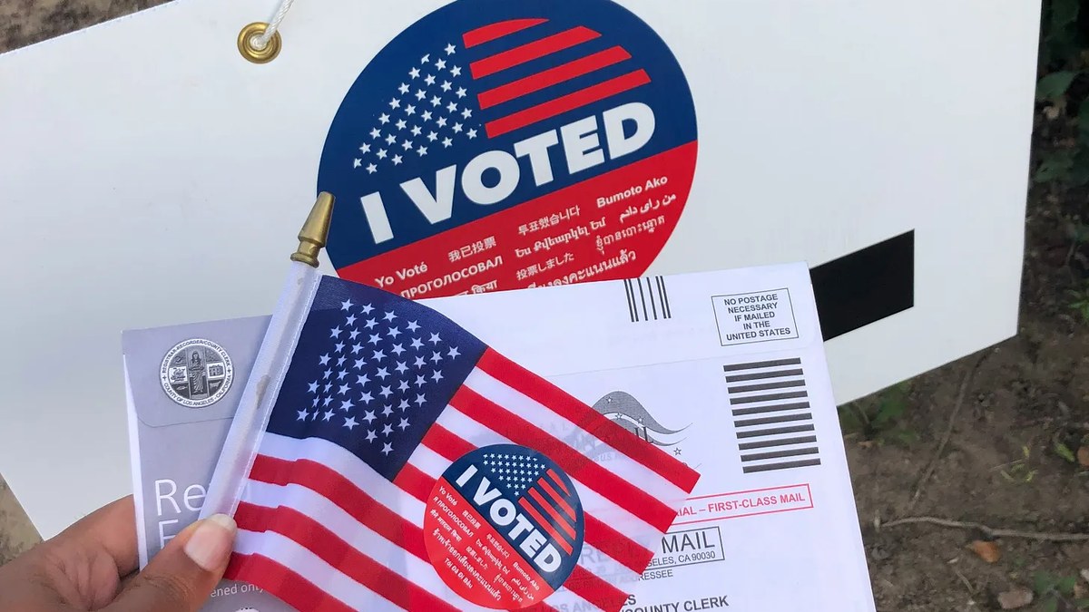 Mail-in ballot envelope and I Voted flag