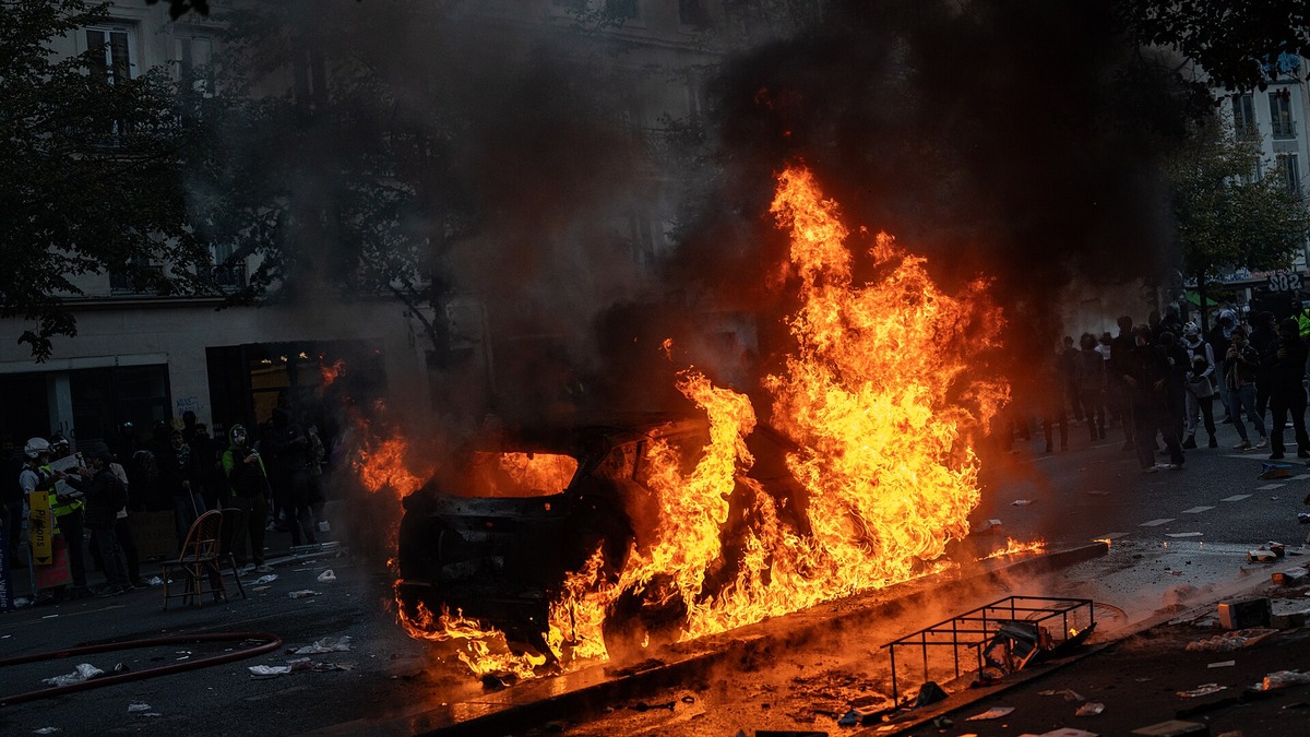 Burning car on a Paris street during the October 17, 2026 riots