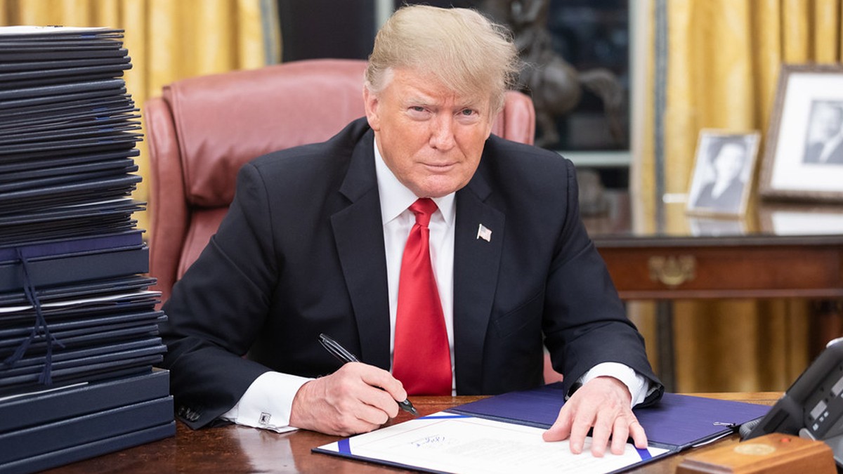 President Trump signing a document at his desk