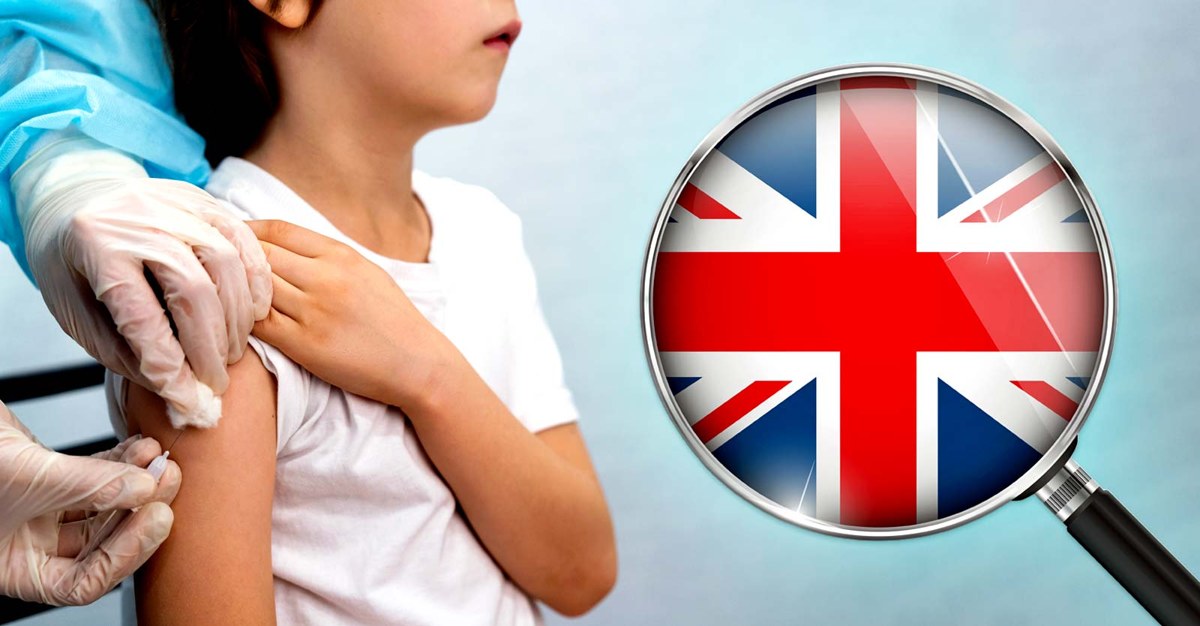 Child receiving an injection with a magnifying glass over a UK flag